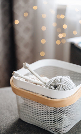 Cozy basket with yarn and knitting needles, perfect for knitting hobby and creative projectsの写真素材