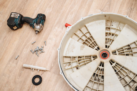 Disassembled washing machine with exposed parts during repair, showing appliance diagnosticsの写真素材
