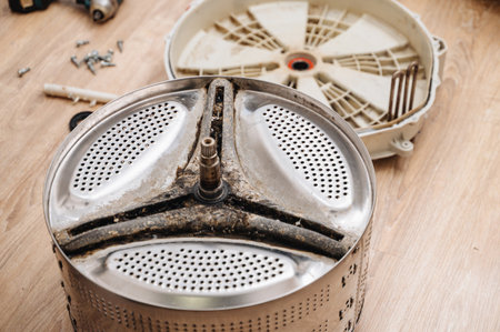 Washing machine drum prepared for repair, showing appliance maintenance and service workの写真素材