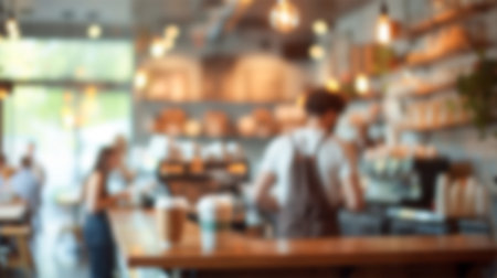 Blurred cozy coffee shop interior with barista and customers.の写真素材