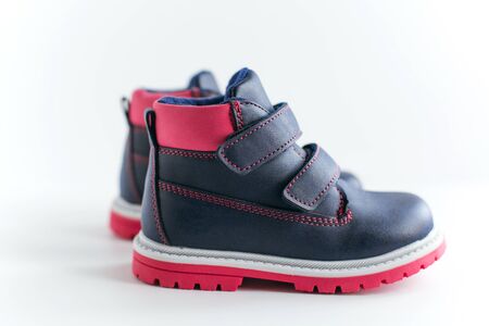isolated dark blue with pink children s spring and autumn leather shoes on a white backgroundの写真素材
