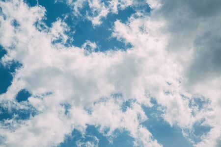 white beautiful fluffy clouds on a blue clear sky
