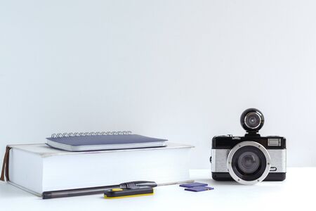 camera, photography tutorial, memory card, pen on a gray background, study conceptの写真素材