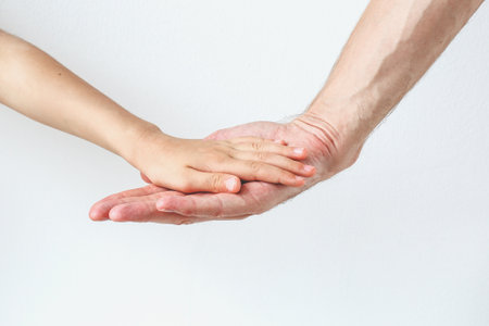 hand of child and father on white background.の写真素材