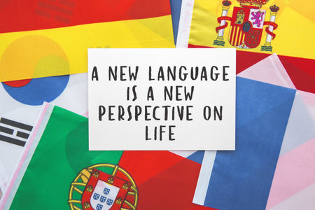 motivational quote about language learning on a white card, surrounded by international flags,...