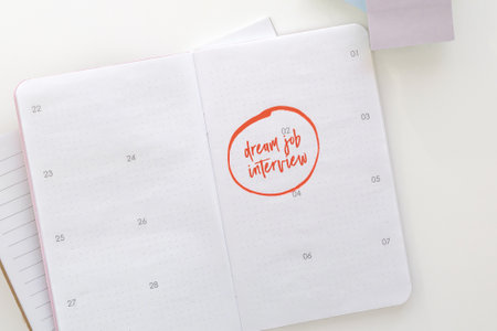 calendar planner notebook with description dream job interview marked and circled with marker.