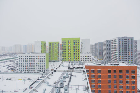 urban modern landscape: multi-colored new buildings residential buildings, windows, air conditioning, facades, roof in winterの写真素材
