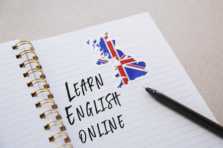 notepad with the inscription learn English online, Flag of the Great Britain and country map, pen, foreign language learning conceptの写真素材