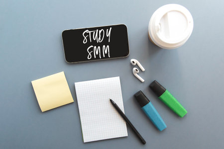 smartphone, wireless headphones, notepad, markers, coffee cup, inscription study smm online...