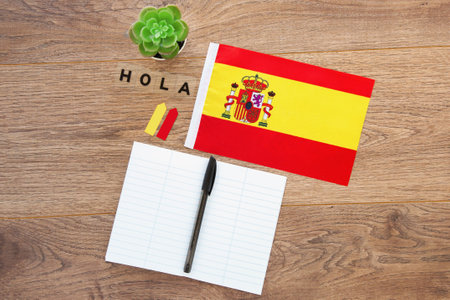 spain national flag, notebook, inscription hello in spanish, on the desktop, foreign language learning concept 1の写真素材