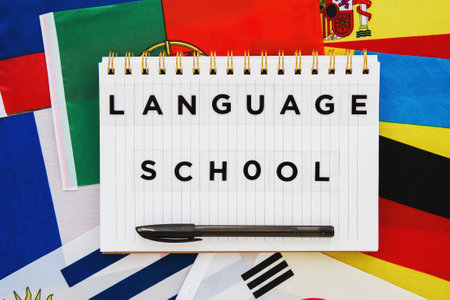 copybook with the inscription language school on the background of the national flags of different...