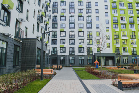 new residential quarter of new buildings: a modern playground in the courtyard of an apartment building with a bright facadeの写真素材