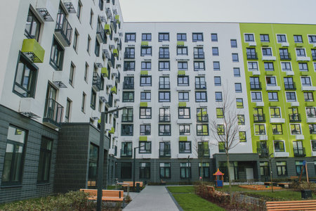 new residential quarter of new buildings: a modern playground in the courtyard of an apartment building with a bright facadeの写真素材