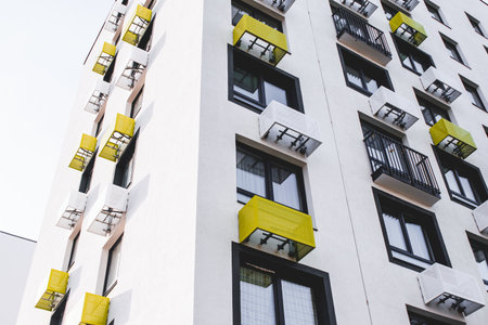 urban modern landscape: multi-colored facade geometry of a new modern apartment building, windows and air conditioningの写真素材