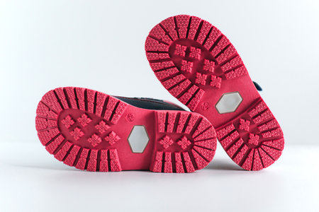 isolated pink sole of children's shoes on a white backgroundの写真素材