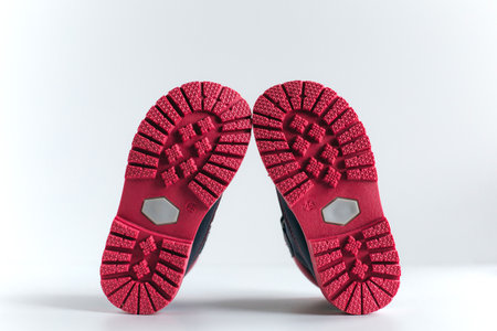 isolated pink sole of children's shoes on a white backgroundの写真素材
