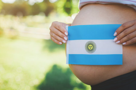 bare belly of a pregnant girl with the flag of the Argentina.の写真素材