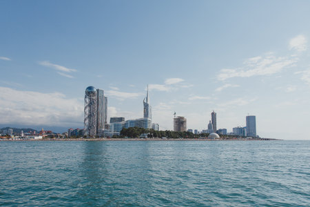 08.2022, Batumi, Georgia: View of the Batumi embankment from the sea on a hot summer day, Ferris wheel, alphabet tower, beachesの写真素材