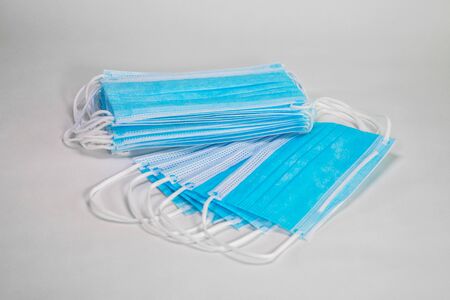 Medical sterile disposable masks. Blue medical masks on a white background.