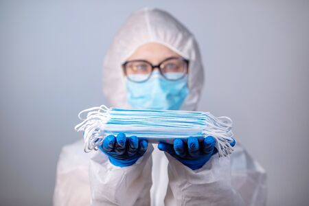 COVID-19. 2019 Novel Coronavirus (2019-nCoV) concept. Young girl doctor in a white protective coat...