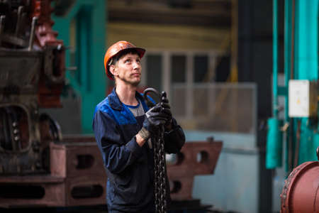 Summer, 2016 - Ussuriysk, Primorsky Krai - Ussuriysky Locomotive Repair Plant. Workers stand behind...
