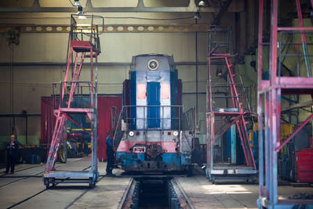 Summer, 2016 - Ussuriysk, Primorsky Krai - Ussuriysky Locomotive Repair Plant. An old locomotive car is being repaired in a railway depotのeditorial素材