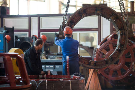 Summer, 2016 - Ussuriysk, Primorsky Krai - Ussuriysky Locomotive Repair Plant. Workers stand behind...