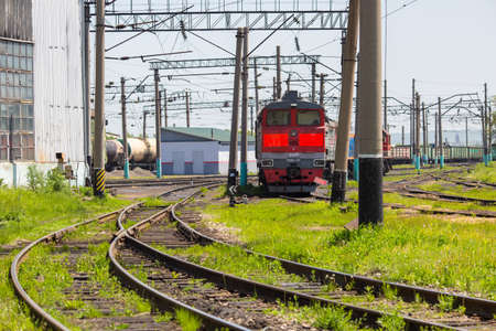 An old red locomotive stands on the railway tracks.のeditorial素材
