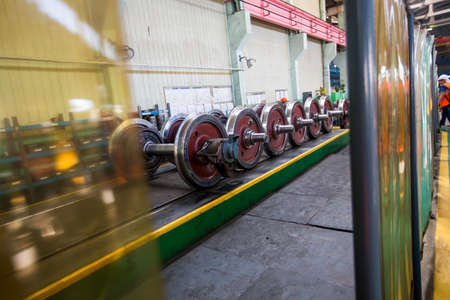 Axles with wheels of railway cars lie in a row at a repair plantのeditorial素材