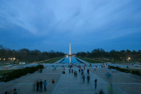 People walking along the National Mall against the backdrop of the Washington Monument in the...