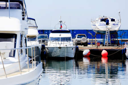 Summer, 2016 - Vladivostok, Primorsky region - Beautiful yachts and boats are in the yacht club. Snow-white yachts against the blue sky.のeditorial素材