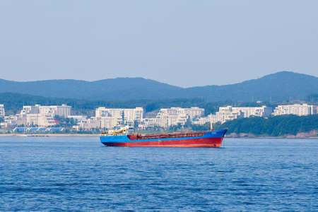 Summer, 2016 - Vladivostok, Russia - A merchant ship stands on the roadstead in the Golden Horn Bay...
