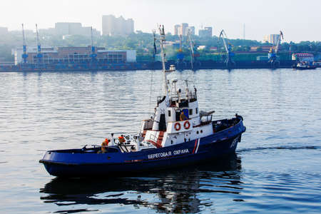 A Coast Guard boat goes at high speed through the water area of Vladivostokのeditorial素材