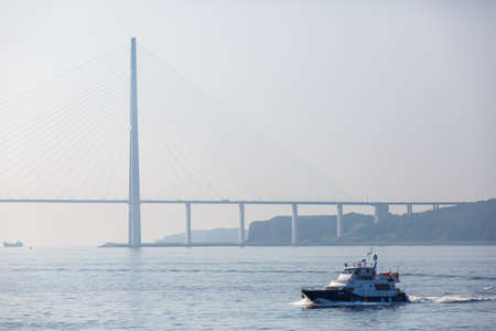 A Coast Guard boat goes at high speed through the water area of Vladivostokのeditorial素材