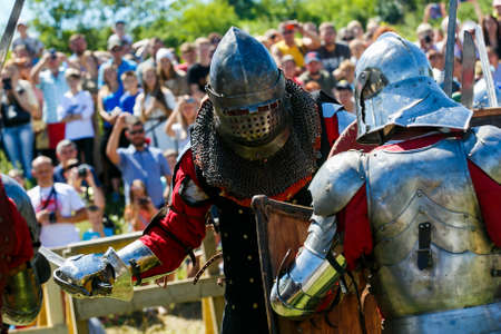 Knight Tournament. Medieval restorers fight with swords in armor at a knightly tournamentのeditorial素材
