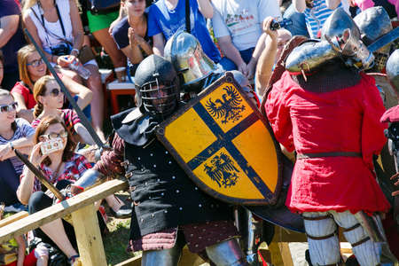 Knight Tournament. Medieval restorers fight with swords in armor at a knightly tournamentのeditorial素材