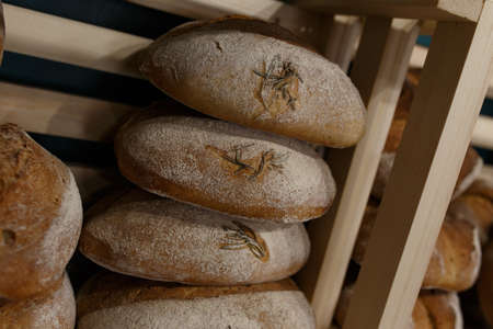 Fresh baked goods are beautifully arranged on display in wooden crates.