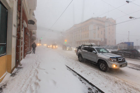 January, 2016 - Vladivostok, Russia - Heavy snowfall in Vladivostok. Cars drive during snowfall along the central streets of Vladivostok.のeditorial素材