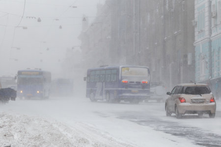 January, 2016 - Vladivostok, Russia - Heavy snowfall in Vladivostok. Snow-covered cars stand along the roadside during heavy snowのeditorial素材