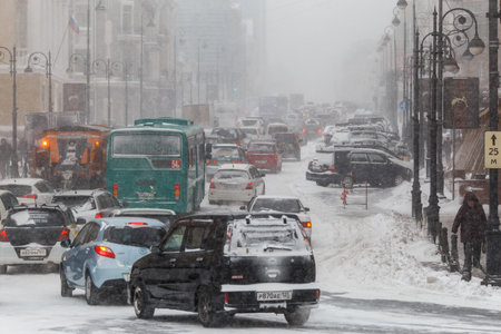 January, 2016 - Vladivostok, Russia - Heavy snowfall in Vladivostok. Snow-covered cars stand along the roadside during heavy snowのeditorial素材