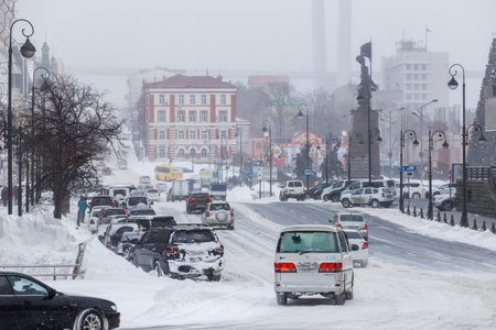 January, 2016 - Vladivostok, Russia - Heavy snowfall in Vladivostok. Snow-covered cars stand along the roadside during heavy snowのeditorial素材