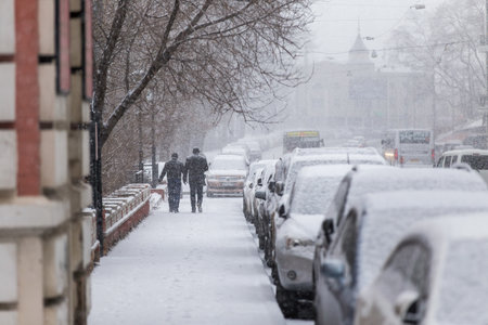 January, 2016 - Vladivostok, Russia - Heavy snowfall in Vladivostok. People walk along the central streets of Vladivostok covered with snow. Pedestrians walk past large snowdrifts through the cityのeditorial素材