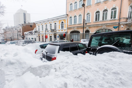 January, 2016 - Vladivostok, Russia - Heavy snowfall in Vladivostok. Snow-covered cars stand along the roadside during heavy snowのeditorial素材