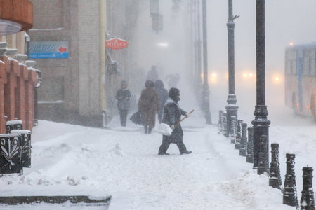 January, 2016 - Vladivostok, Russia - Heavy snowfall in Vladivostok. People walk along the central streets of Vladivostok covered with snow. Pedestrians walk past large snowdrifts through the cityのeditorial素材