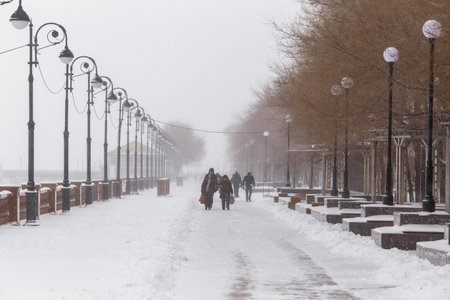January, 2016 - Vladivostok, Russia - Heavy snowfall in Vladivostok. Lonely man walks past the inscription Happy New Year during heavy snowfallのeditorial素材