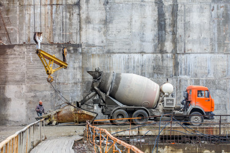 Autumn, 2016 - Magadan, Russia - Construction of the Ust-Srednekanskaya hydroelectric station. Hydroelectric workers sit by the turbine in the engine roomのeditorial素材
