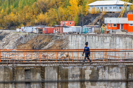 Autumn, 2016 - Magadan, Russia - Construction of the Ust-Srednekanskaya hydroelectric station. Hydroelectric workers sit by the turbine in the engine roomのeditorial素材