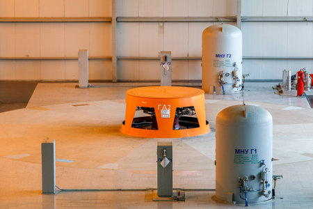 Autumn, 2016 - Magadan, Russia - Construction of the Ust-Srednekanskaya hydroelectric station. Hydroelectric workers sit by the turbine in the engine roomのeditorial素材