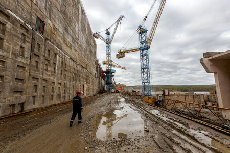 Autumn, 2016 - Magadan, Russia - Construction of the Ust-Srednekanskaya hydroelectric station. Construction of a river dam across the Kolyma River in Russiaのeditorial素材