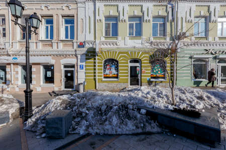 Vladivostok, Russia, 2017 - Dirty street in Vladivostok. Big dirty drifts of snow lie on the pedestrian street of the port cityのeditorial素材